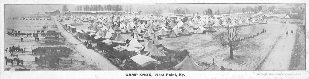 1918 photograph of Camp Knox tent city at West Point, Kentucky, showing rows of canvas tents, horse teams, wagons, and early motorized vehicles.
