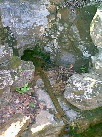 Fort Duffield spring carved into the limestone hillside, showing the hand‑cut basins and visible drill‑hole marks created by Union soldiers in the winter of 1861–62.