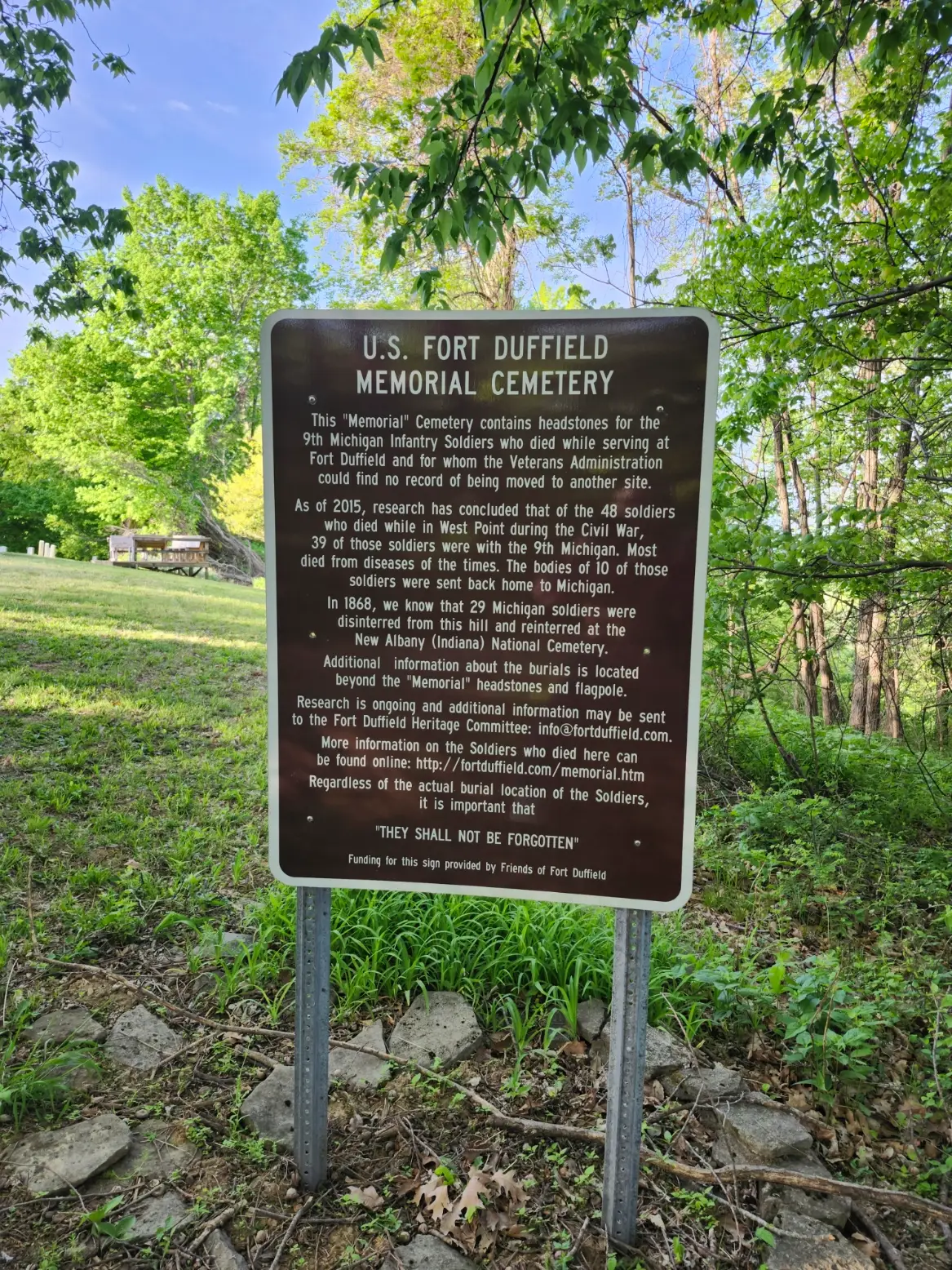 Interpretive sign describing the cemetery and memorial area